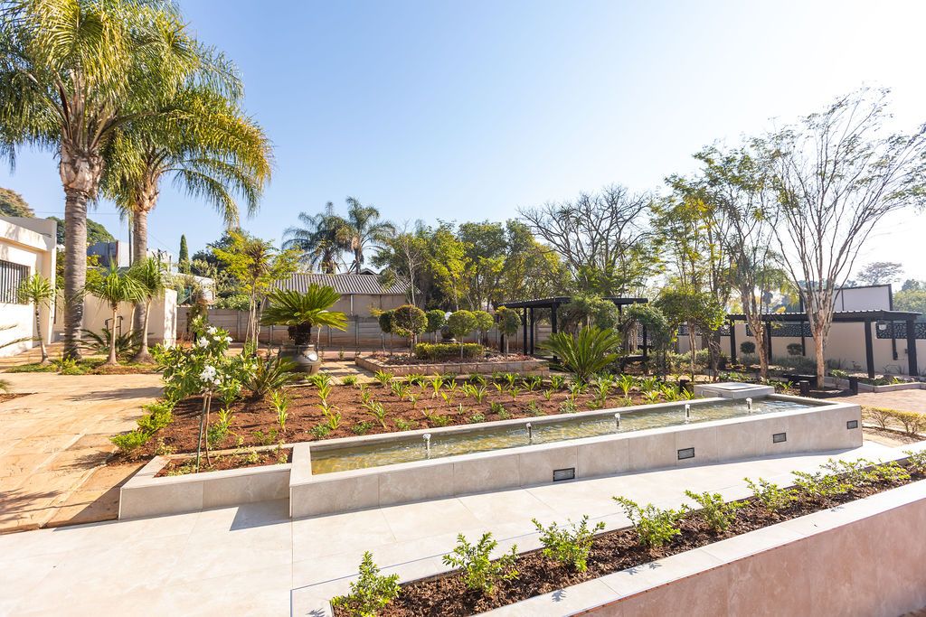 Landscaped garden beds and lawns in the grounds of The Victoria